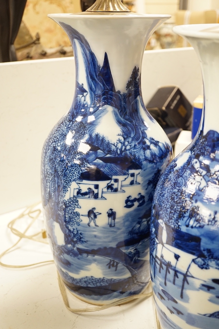 A pair of 20th century Chinese blue and white porcelain table lamps, 43 cms high excluding light fitting.